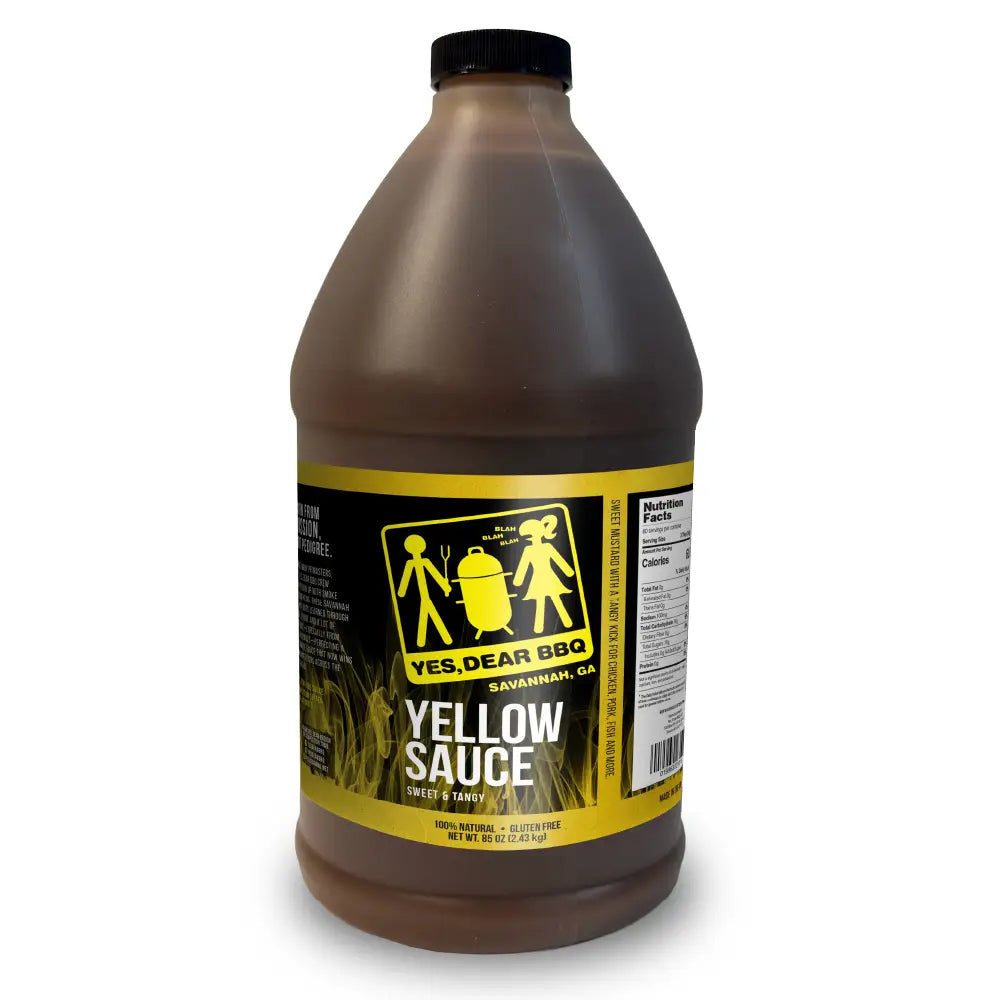 A large plastic jug of Yes, Dear BBQ Yellow Sauce, featuring a black cap and a black and yellow label, shown on a white background.