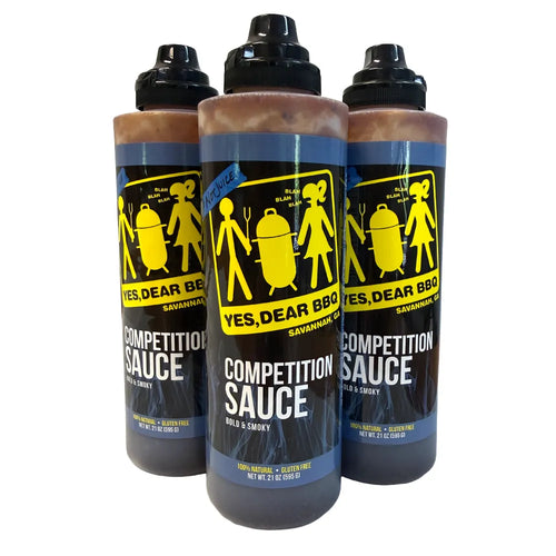 Three squeeze bottles of bbq sauce 'Yes, Dear BBQ' Competition Sauce arranged in a group on a plain white background.