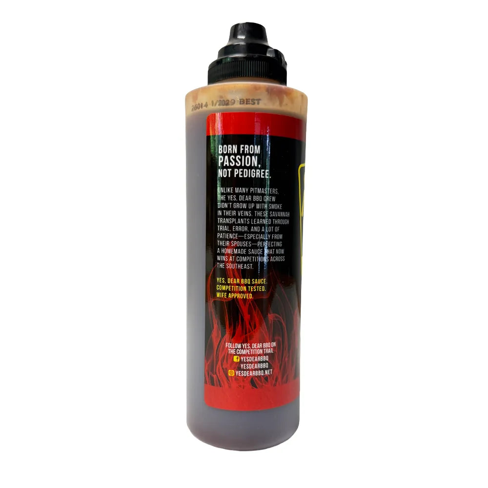 side view of red sauce bottle on white background
